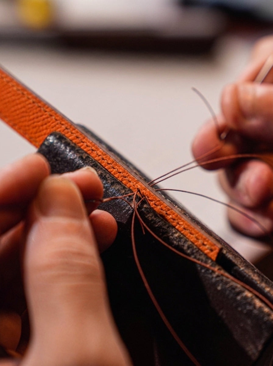 Hand saddle-stitching a leather watch strap with two needles